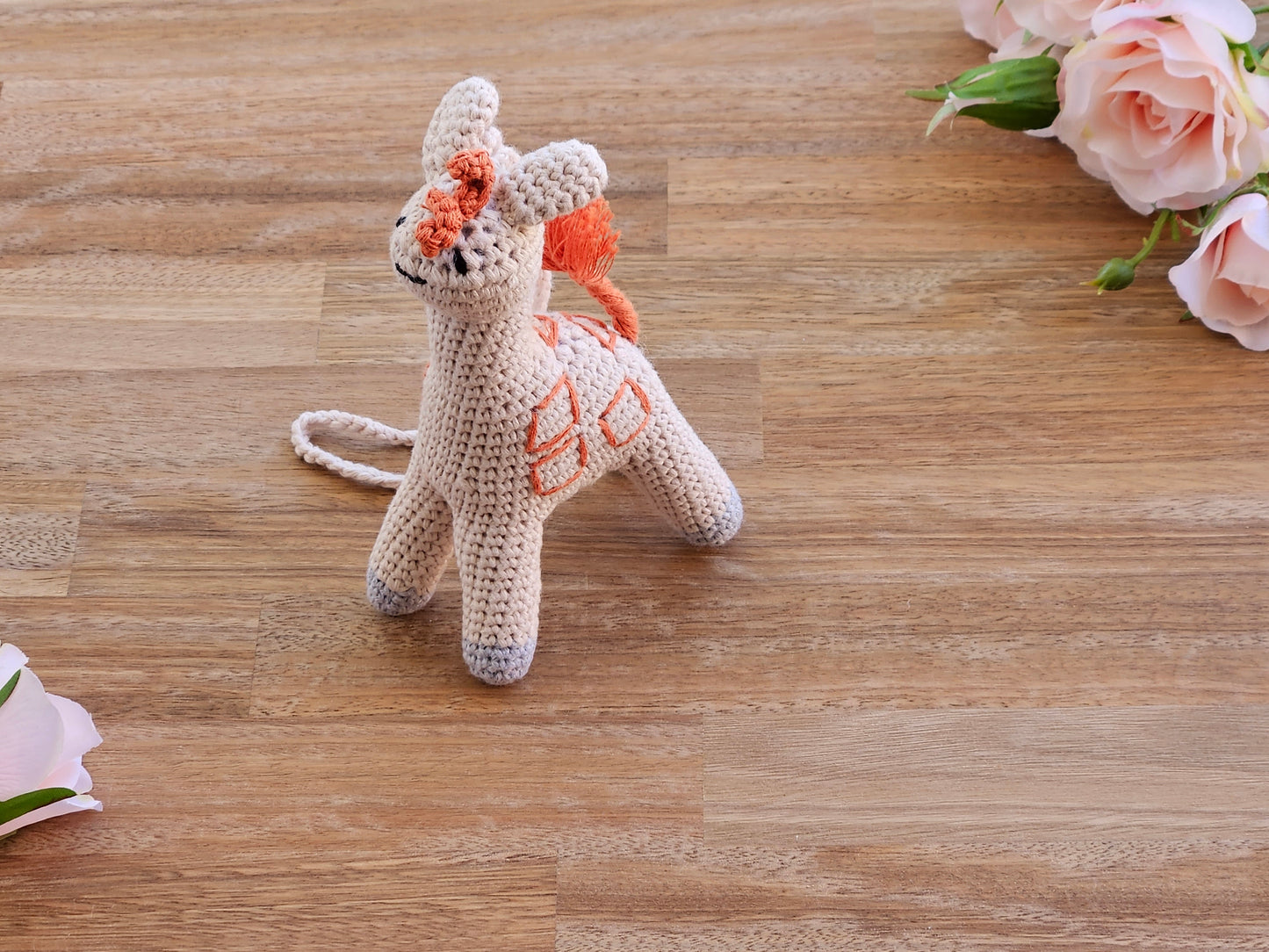 Beige and orange giraffe hanging toy