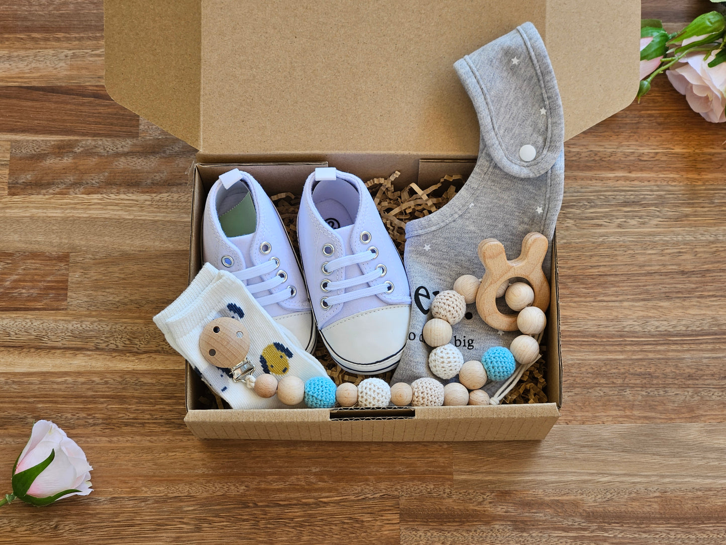 Baby gift box includes gym boot, grey bib, dog pattern sock with a beaded ring toy and a beaded pacifier chain