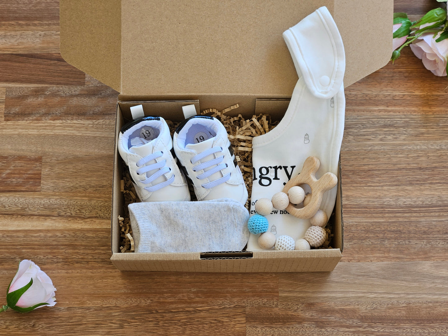 Baby gift box includes white/black stripe baby sneaker, grey ankle socks, white bib and beaded teether ring toy