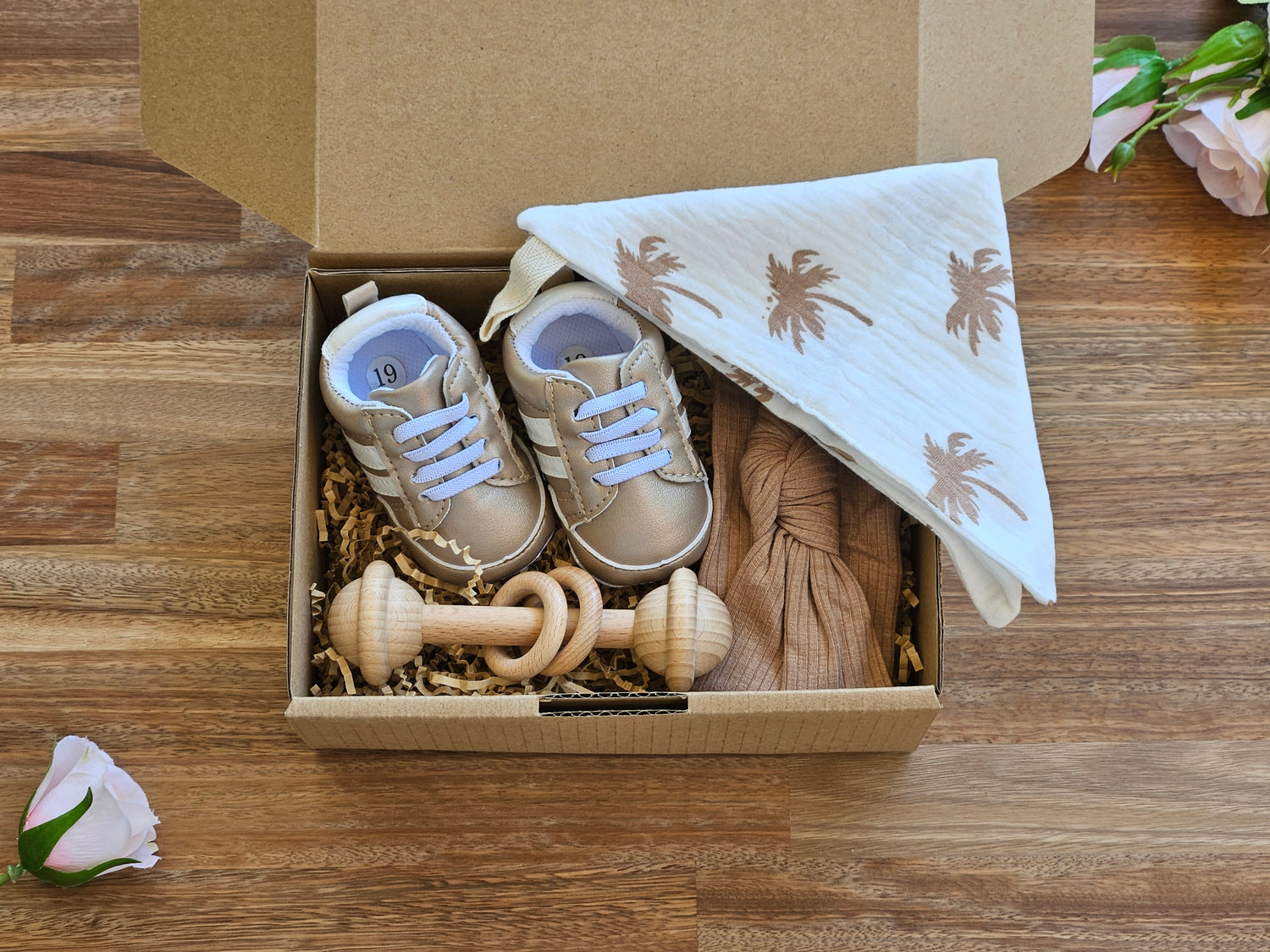 Baby giftbox includes Champagne colour baby sneaker with knot headband wooden bar rattle and a muslin burp cloth