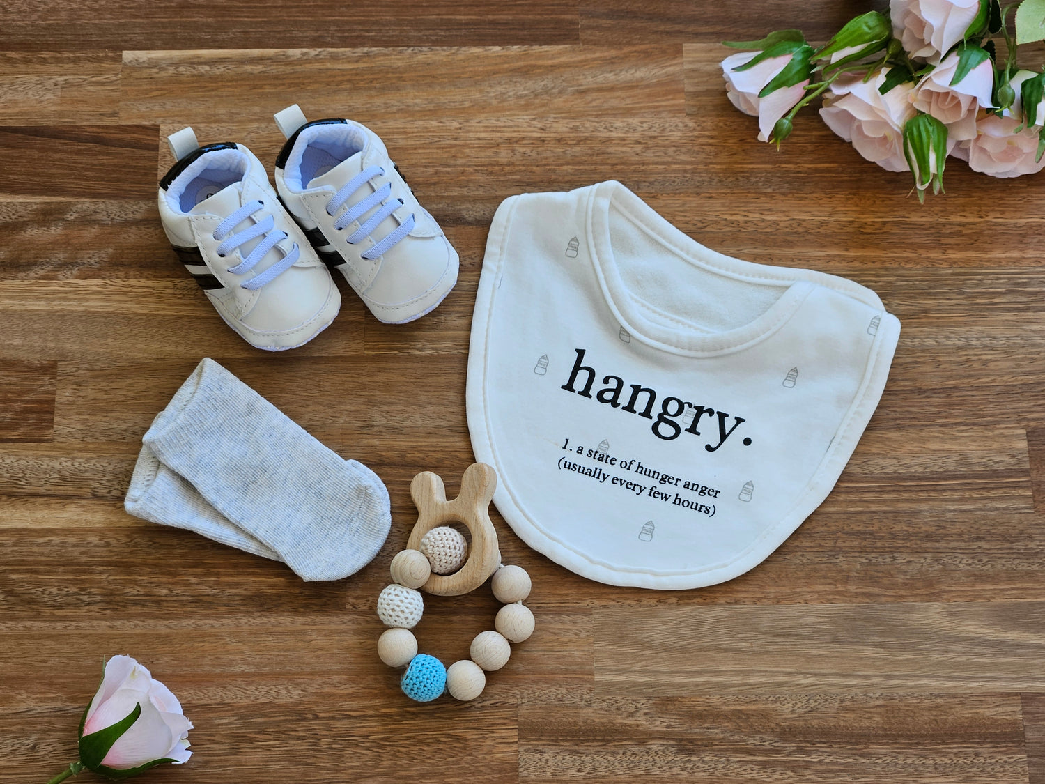 white/black stripe baby sneaker, grey ankle socks, white bib and beaded teether ring toy