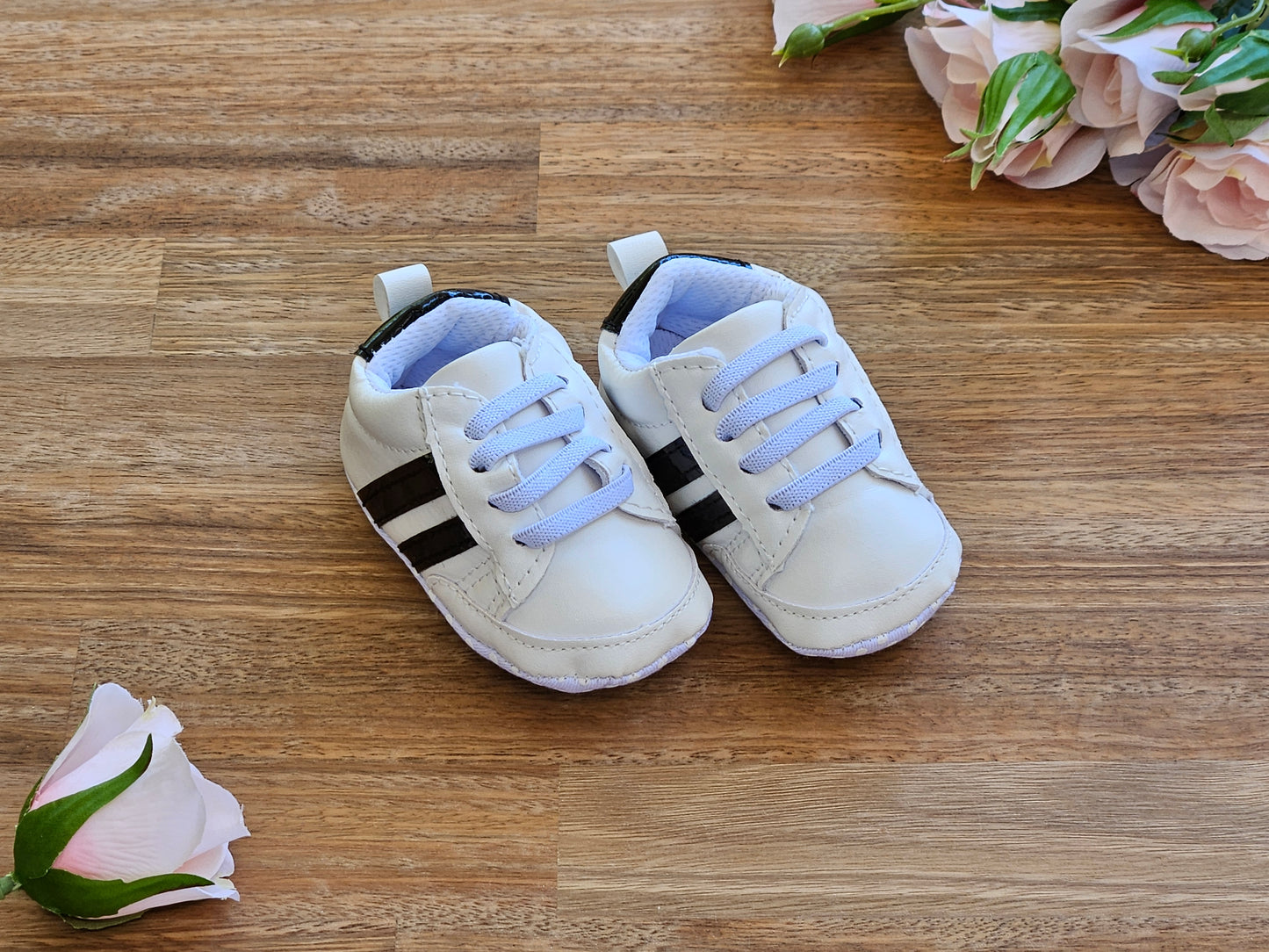 White sneaker with black stripes