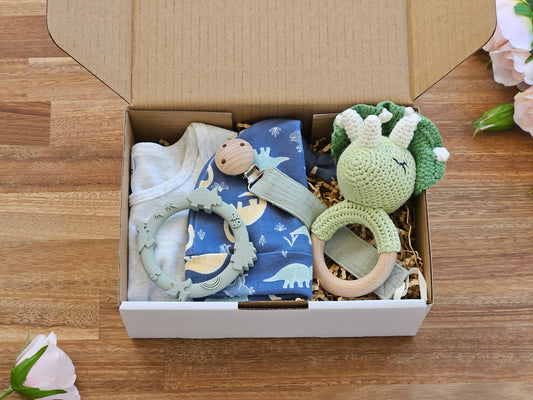 Gift box includes Dinosaur hat and beige romper with Triceratops rattle, Silicone teether and a muslin pacifier chain