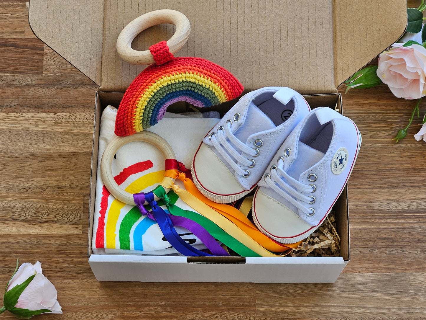 Gift box includes  White T_Shirt with rainbow image, grey organic cotton leggings, white jogger shoe, rainbow rattle + ribbon teether ring