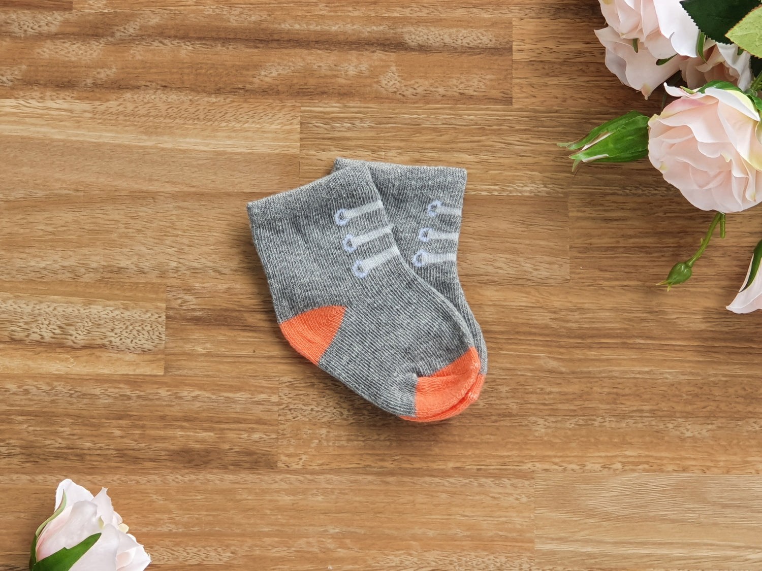 Grey and orange sock with shoe lace pattern