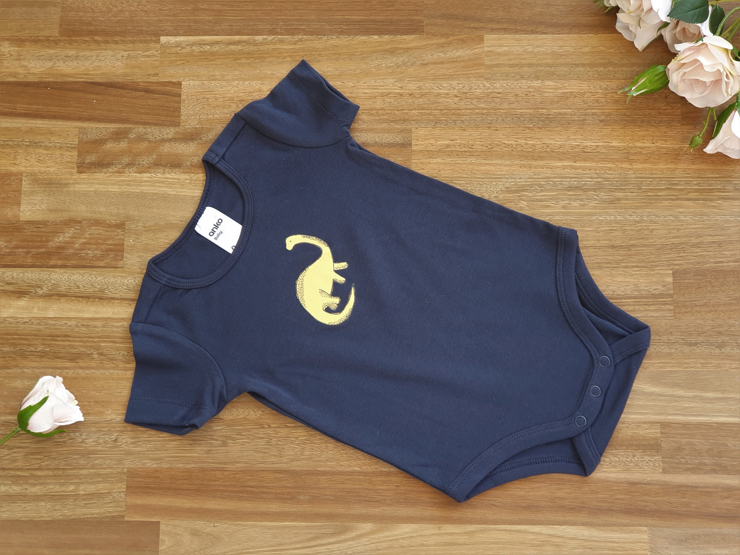 Blue romper with dinosaur image