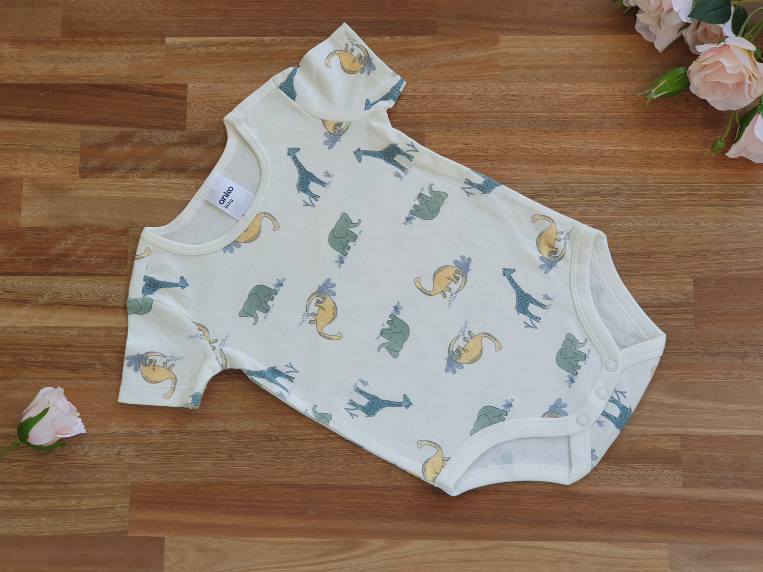 Beige romper with dinosaurs and animals