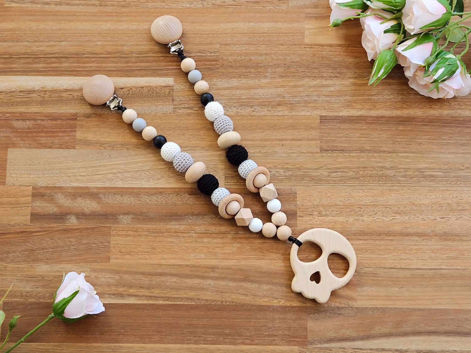 Beaded pram garland toy, includes wooden skull teether toy and is black, grey, white color beads